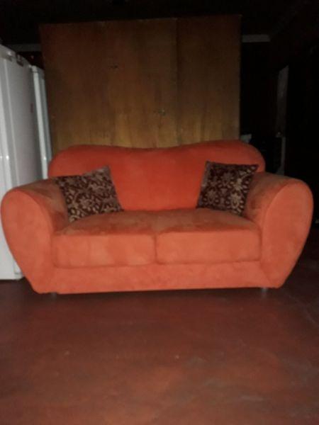 2 x two seater suede couches (Orange)