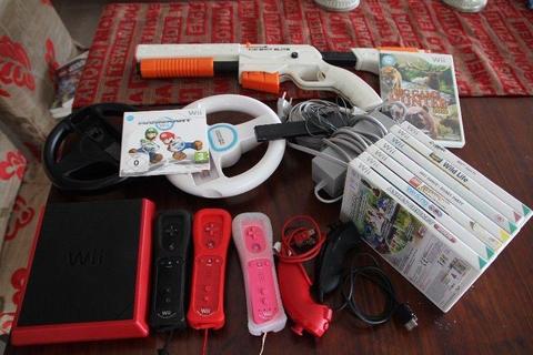 Wii Console, 3 controllers, 2 nunchucks, micraphone, hunting gun, 2 steering wheel, 10 games