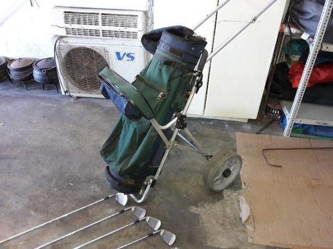 Golf clubs and bag on wheels - right hand