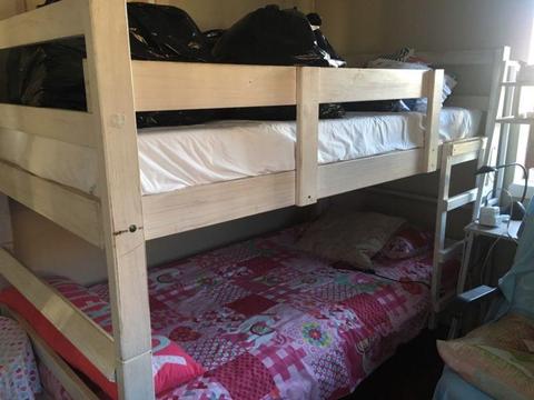 Wooden bunk beds and mattresses