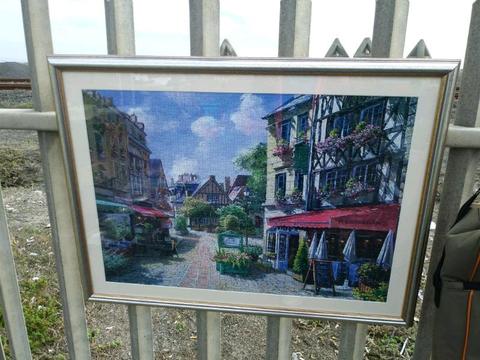 Framed puzzle picture of a Street cafe