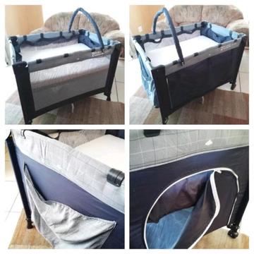 Campcot with upper level for a newborn, mattress with sheet, toybar & carry/storage bag