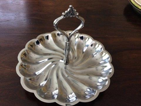 Silver coloured dish with handle