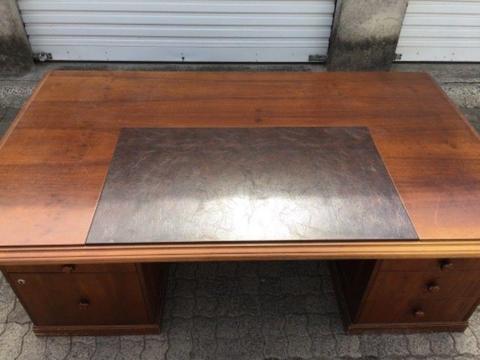 Large wooden desk with brown leather inlay