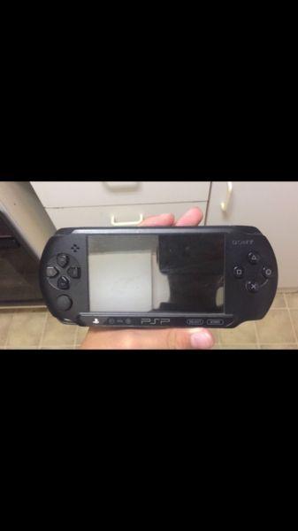 Black charcoal psp E1004 with 6games a pouch a brand new charger nd a connecting cable