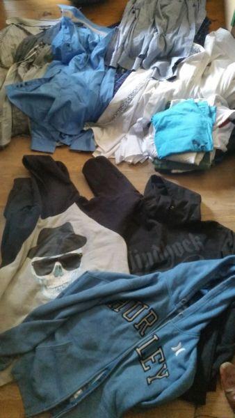 Stacks of mens clothing for sale