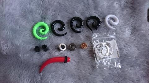 Assorted ear stretching spirals, tunnels and plugs
