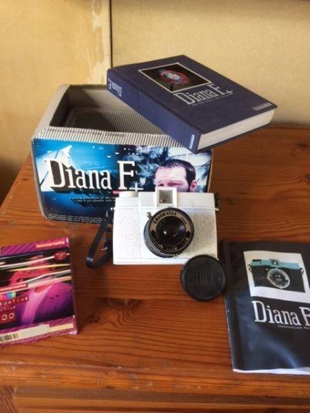 Diana F+ camera by Lomography with film and book