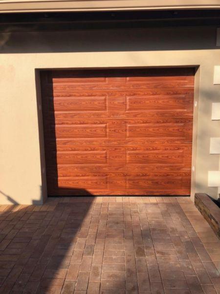 Single and double woodlook aluzinc sectional doors in Northern Pretoria