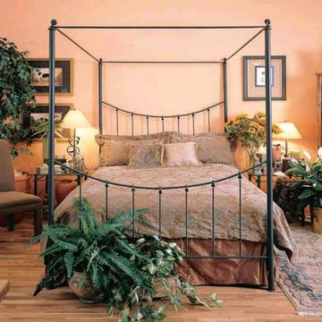Four poster wrought iron bed