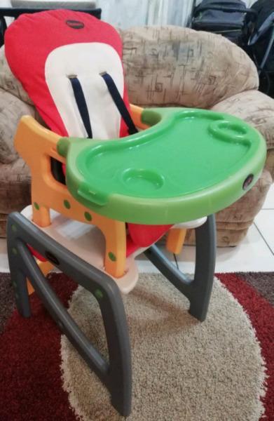 Feeding chair which converts into a table and chair