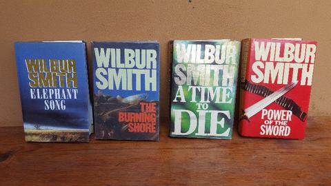 Collection of 4 large hard cover Wilbur Smith books