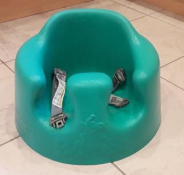 Green bumbo seat with safety straps