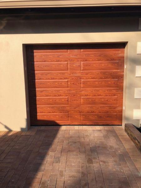 Single and double woodlook aluzinc sectional doors in Parktown