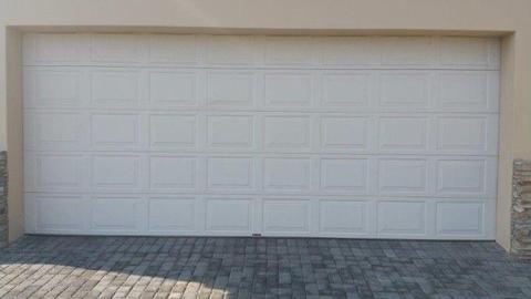Double electric garage door. White
