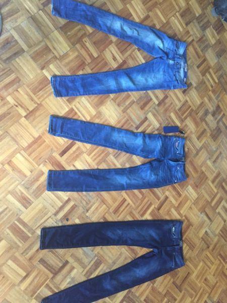 3 pairs of brand new superdry jeans and a pair of guess jeans