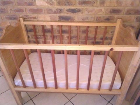 Baby cot in excellent condition, wooden with gabled design and snuggle fit mattress