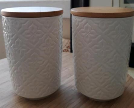 A pair of white new bone china storage canisters