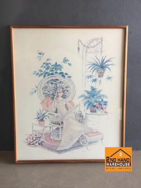 Framed wall painting of lady sitting in chair