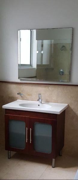 vanity cupboard with top and mixer and mirror