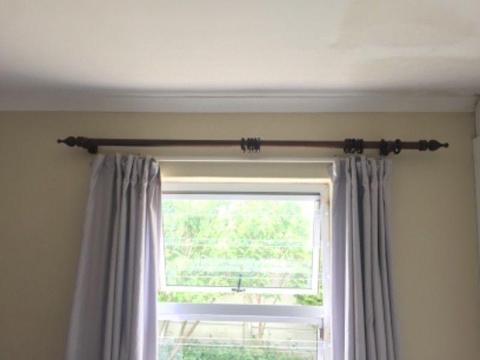 Dark wood curtain rail
