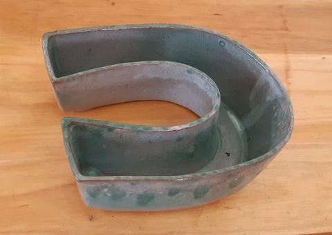 Globe horse shoe pottery dish