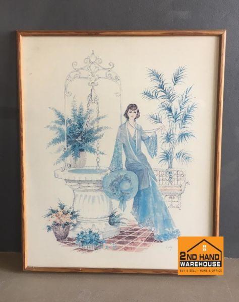 Framed wall painting of lady sitting