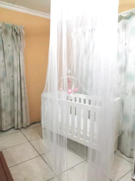 Adjustable wooden cot with accessories