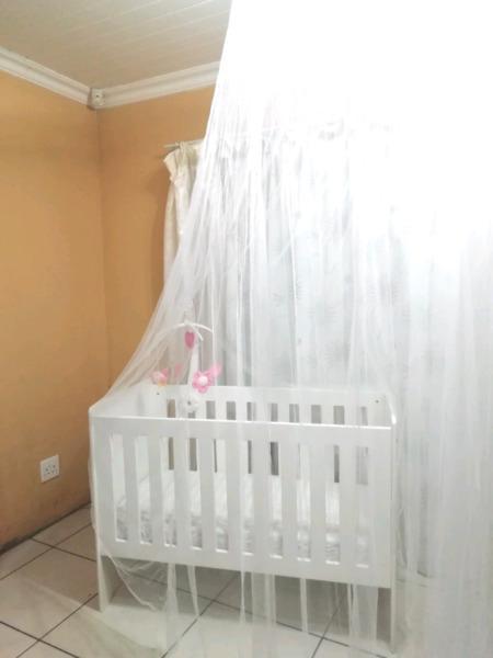 Adjustable wooden cot with accessories