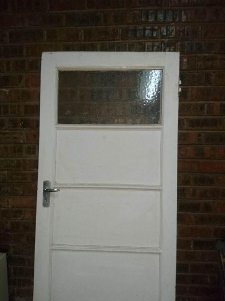 Wooden door with glass panel