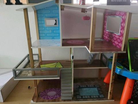 Wooden dollhouse with furniture accessories