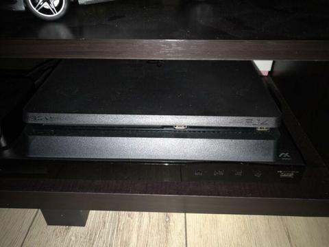 PS4 1TB SlimLine with controllers, charging stand and games for sale. Cash Only!