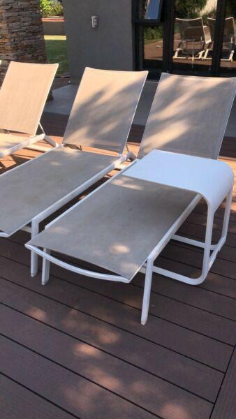 Sun loungers with side tables