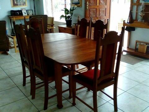Antique solid oak dining table and six chairs with Grandpa end Grandma arm chairs. 
