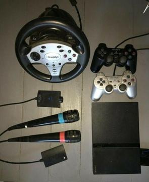 Playstation 2 (PS2) with singstar, eye toy, steering wheel and games 