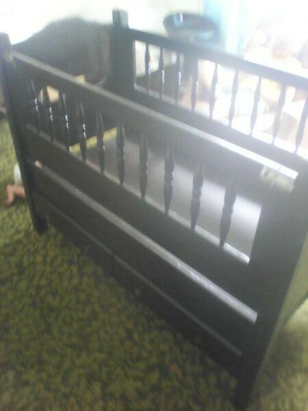 Wooden Cot for sale. Includes mattress. 