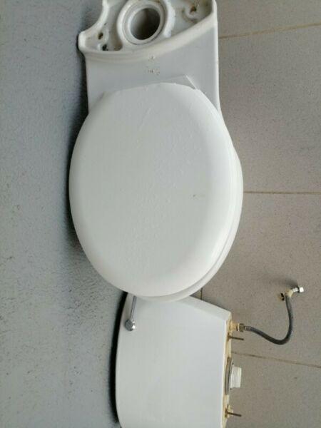 Bathroom basin/mixer and toilet with plumbing. 
