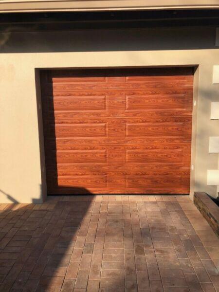 Single and double woodlook aluzinc sectional doors in Arcadia and Sunnyside 