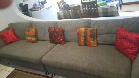 Long couch seats 6 or 7 can be split into 2 couches broad seat pillows and high back. Grey 